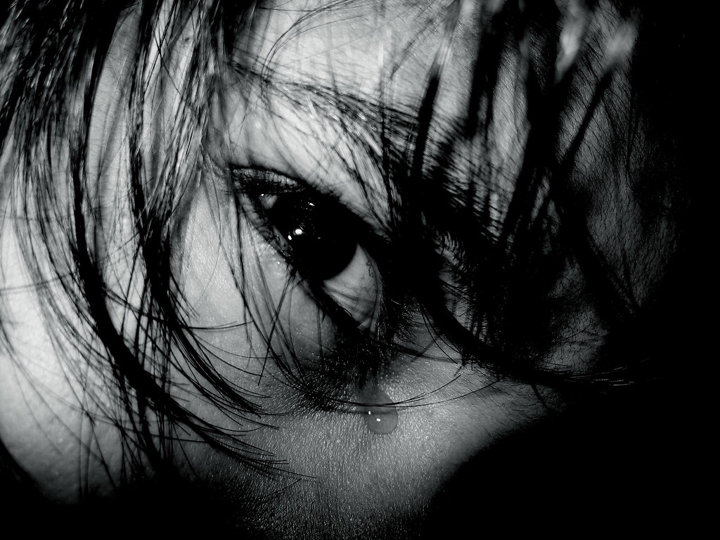 a tear in her dark face